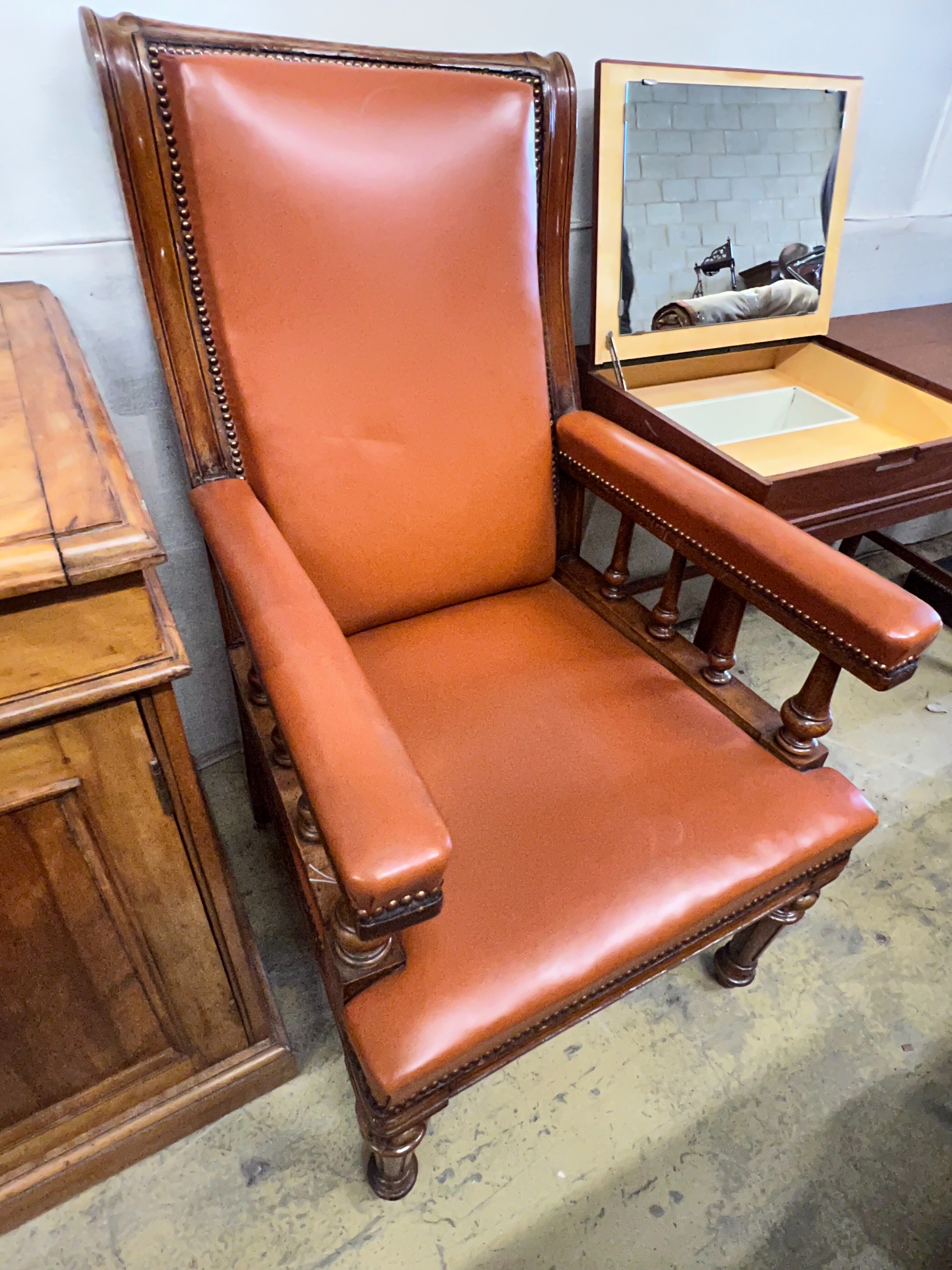 A late Victorian oak and leather library armchair, width 62cm depth 76cm height 110cm